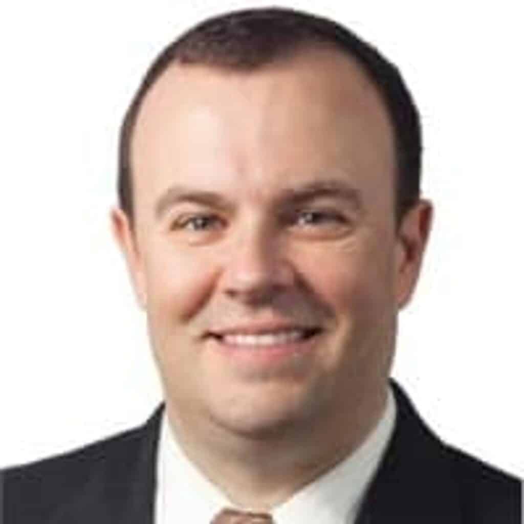 man in a suit smiling professional headshot